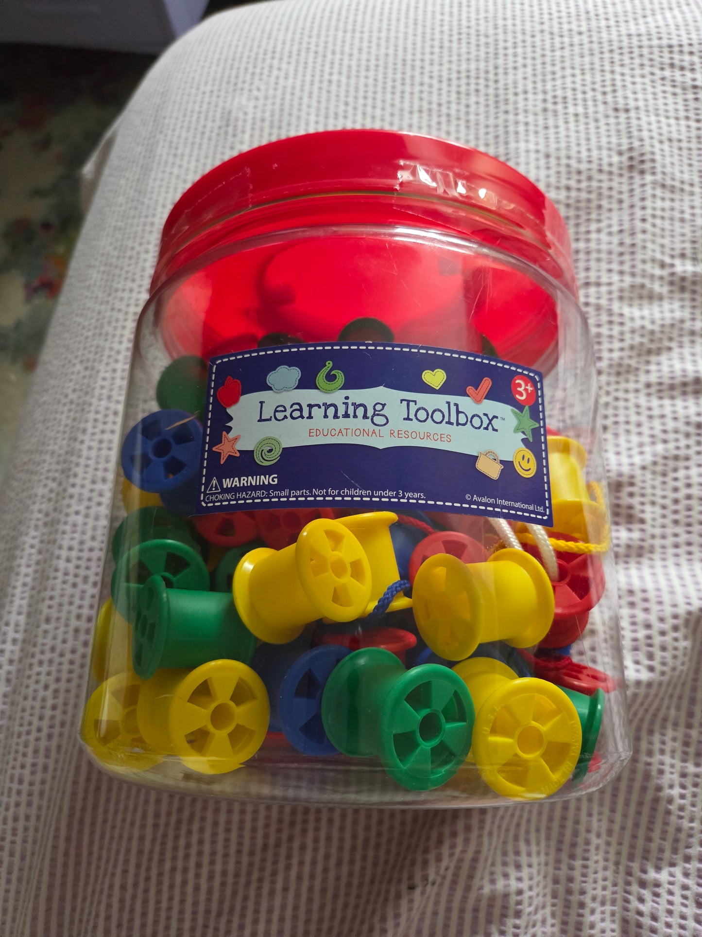 Large jar of threading cotton reels