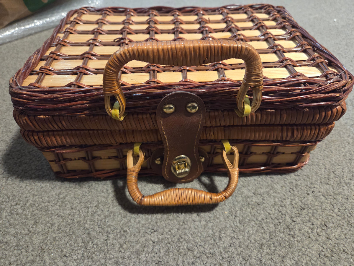 Vintage porcelain tea set in wicker basket